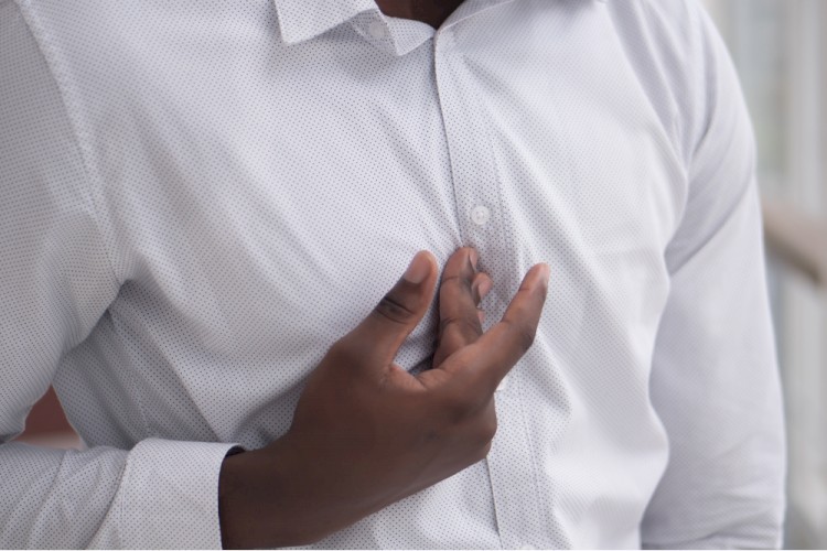 African man suffering from acid reflux or GERD